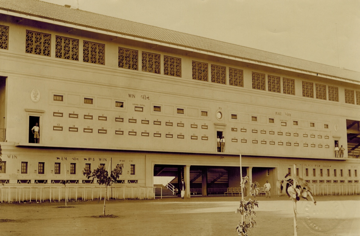 An image of the Grandstand at in Bombay showing the Automatic Totalisators Limited Indicator